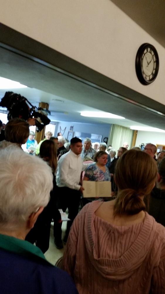 Pedro Lopez and his mother presented of book of names of those arrested in May 2008. She was among those arrested and deported but is now back in the U.S. on a U Visa, which is granted to a person who has suffered as a crime victim and cooperates with law enforcement. At Postville, 172 people, mostly women, qualified for U visas, mostly because of sexual harassment from the plant supervisors. U visas can lead to citizenship and bring in family. (Bernadine Karge)