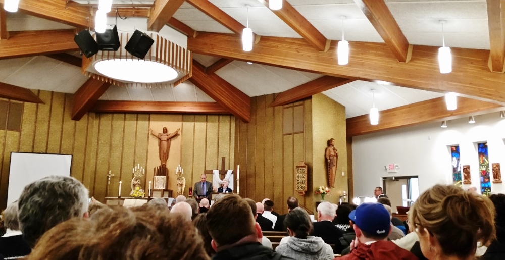 Sr. Mary McCauley speaks at the prayer service, accompanied by interpreter Erika Camayd Freixas. (Bernadine Karge)