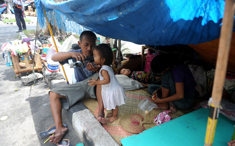 A homeless family lives in a makeshift shelter along a street in Manila, the Philippines, April 23. (Getty Images/AFP/Noel Celis)