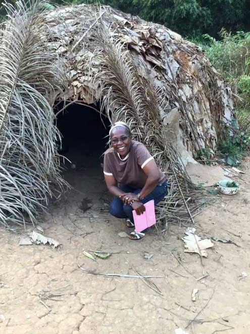Sr. Constance Fonju poses with a shelter the Baka people use in the forest. (Provided by Constance Fonju)