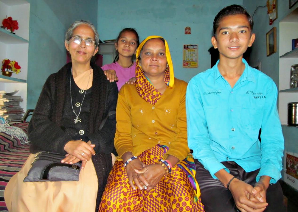 Sr. Mariola Sequeira visits a widow and her children at their home. The nun had helped save the woman from a false case filed by her in-laws. (Saji Thomas)