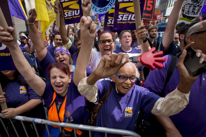 At a July 22, 2015, rally in New York City, people celebrate passage of a recommendation by the New York State Fast Food Wage Board that the minimum wage for fast-food workers be raised to $15 an hour. (CNS/Reuters/Brendan McDermid)