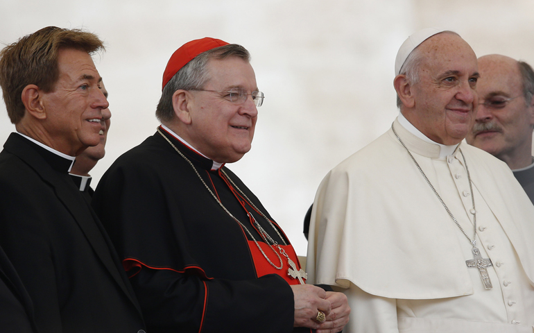 U.S. Cardinal Raymond Burke, center left, and a group of priests pose with Pope Francis during his general audience in St. Peter's Square at the Vatican Sept. 2. (CNS/Paul Haring)