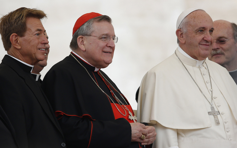 Cardinal Raymond Burke, center left, and a group of priests pose with Pope Francis during his general audience in St. Peter's Square at the Vatican Sept. 2, 2015. (CNS/Paul Haring)