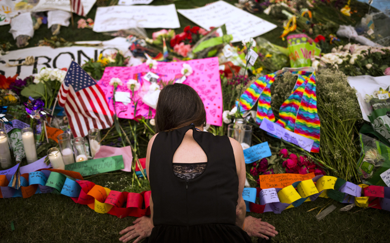 A woman visits a memorial in downtown Orlando, Fla., June 14, that honors the victims of the mass shooting at a gay nightclub. (CNS/John Taggart, EPA)