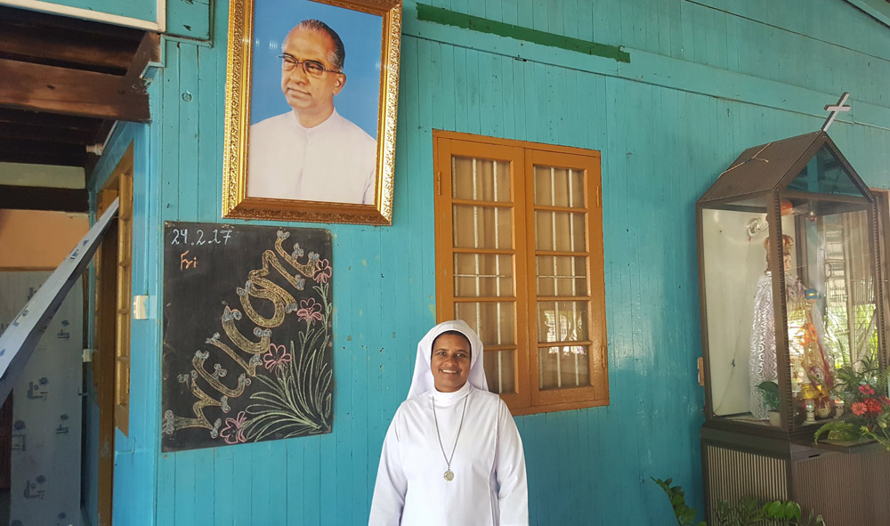 Sr. Salette Mary, Superior of the Servite Sister (Servants of Mary) community in Kyauktan, Myanmar, with a portrait of Fr. Singa Rayar, who was instrumental in starting the 50-acre farm that supports St. Mary’s Home, which cares for orphans and those whose families are too poor to care for them. Photos of Rayar, who died in 2010, are seen throughout the buildings. (GSR photo / Gail DeGeorge)