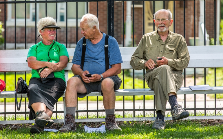 Ann Sabin, Roscoe Hill and Jim Adams sit together on a park bench on the grounds of the Academy of the Sacred Heart in St. Louis after finishing their pilgrimage May 18. (CNS/Lisa Johnston, St. Louis Review)