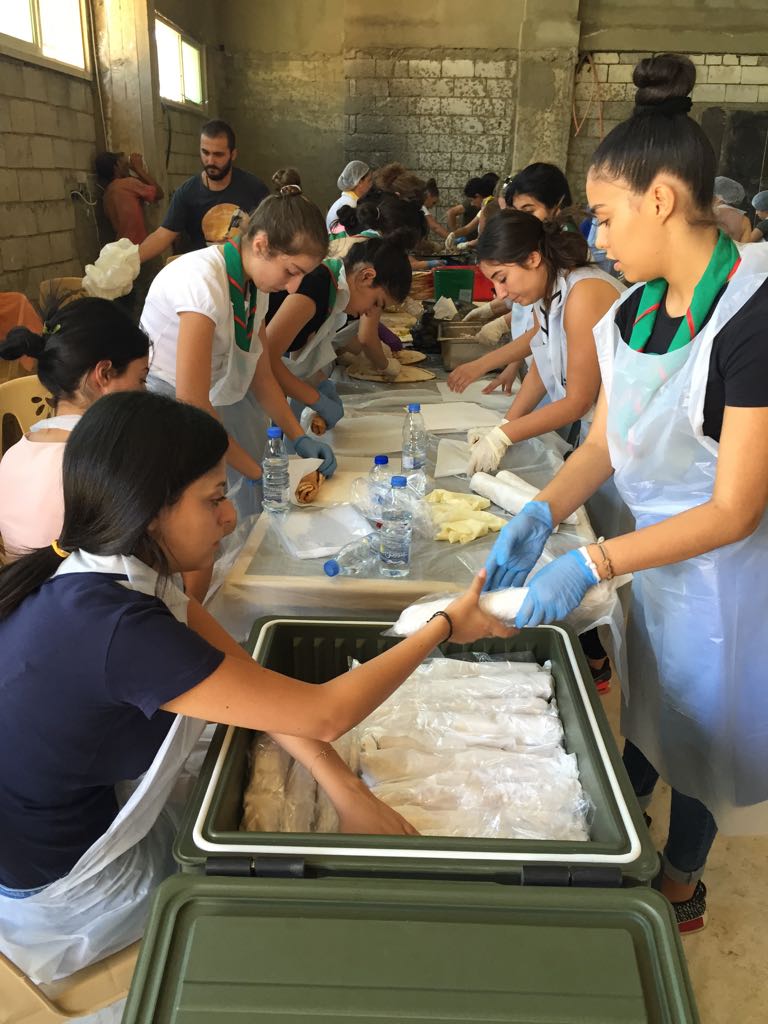 Volunteers prepare approximately 5,000 sandwiches Aug. 22 for the Lebanese army, which is waging an offensive against an Islamic State enclave near Ras Baalbek, Lebanon. Hundreds of volunteers, Christian and Muslim, are involved in the project, spearheaded by Mother Agnes Mariam of the Cross, a Lebanese Carmelite nun. (CNS / Mother Agnes Mariam of the Cross)