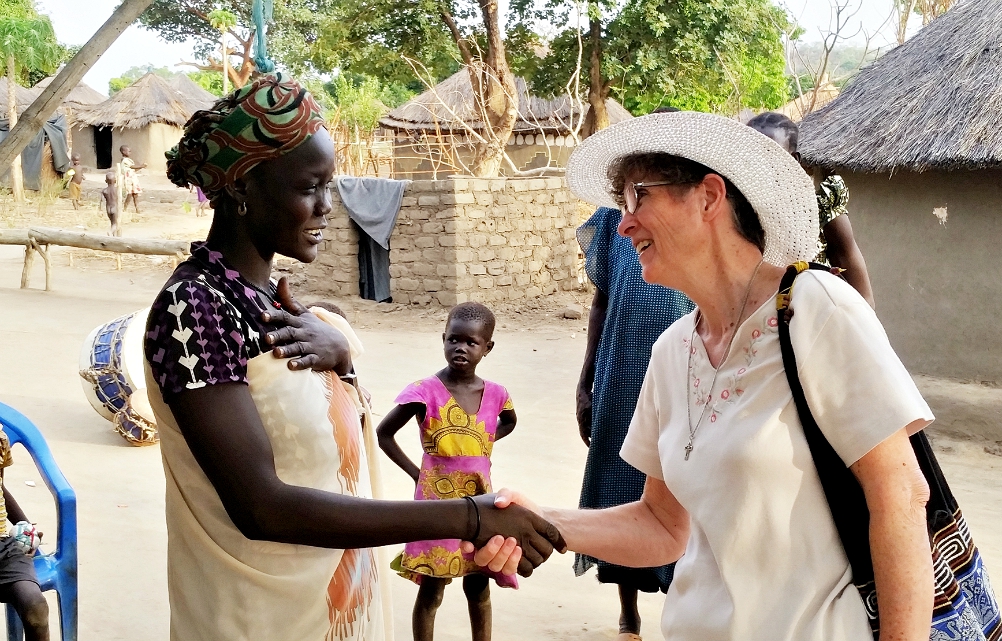 Mercy Sr. Marilyn Lacey greets a South Sudanese refugee at a refugee camp in northern Uganda in January 2018. Ten years ago, Lacey founded Mercy Beyond Borders, a nonprofit group that helps educate girls and support women's entrepreneurial projects in South Sudan and Haiti. (CNS/Courtesy of Sr. Marilyn Lacey)