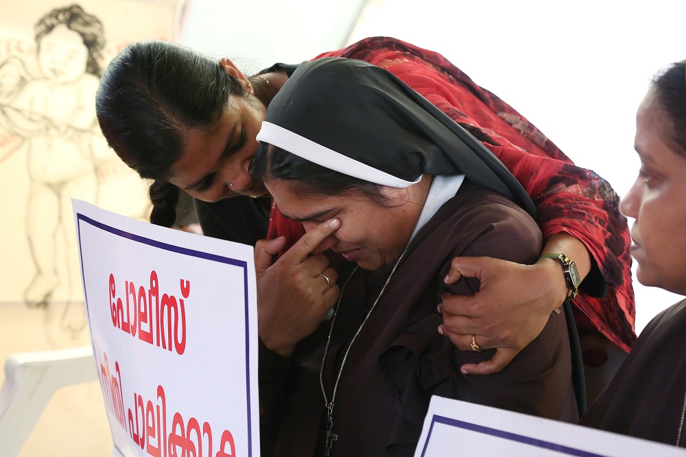 A woman religious is consoled during a Sept. 13 protest in Cochin, India, demanding justice after a nun accused Bishop Franco Bishop Franco Mulakkal of Jalandhar of raping her. (CNS/Sivaram V, Reuters)