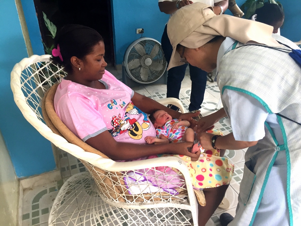 Sr. Anney Taffur checks on a one-day-old newborn, later advising the new mother how to breastfeed. (GSR photo / Soli Salgado)