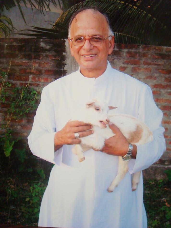 Archbishop Thomas Menamparampil with a lamb during a village mission visit