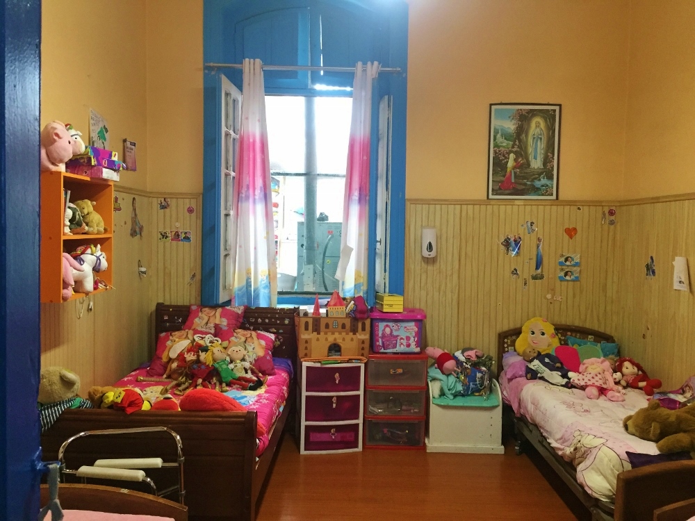 Two to four children share a bedroom, all filled with toys and drawings, at Santa Clara Home in Santiago, Chile. (GSR photo / Soli Salgado)