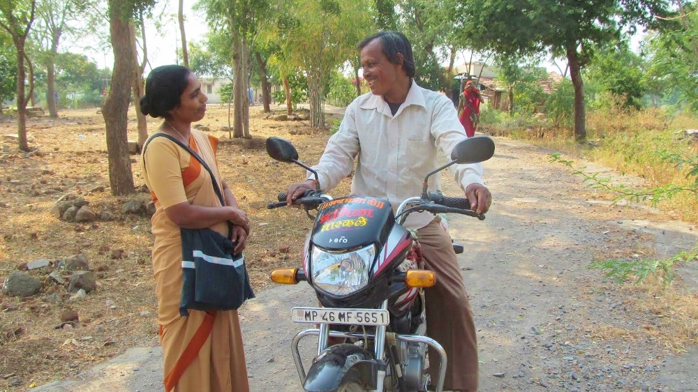 Sr. Julia Thundathil chats on the road with one of her volunteers. (GSR photo / Saji Thomas)