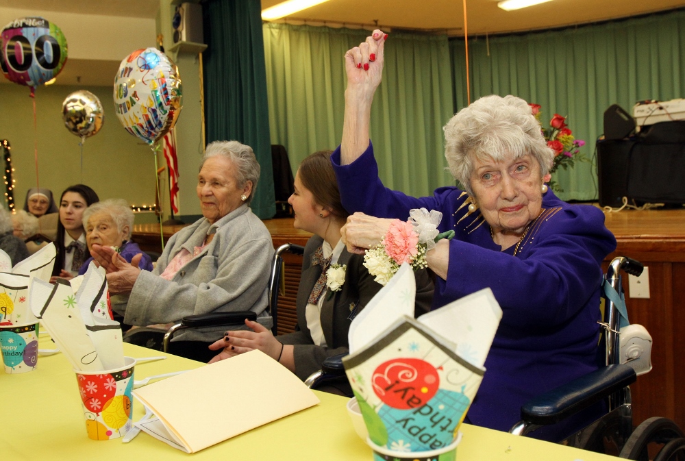 Honoree Jeanette Clark, who will turn 100 Nov. 23, grooves to the music during the birthday party. (CNS photo/Gregory A. Shemitz)