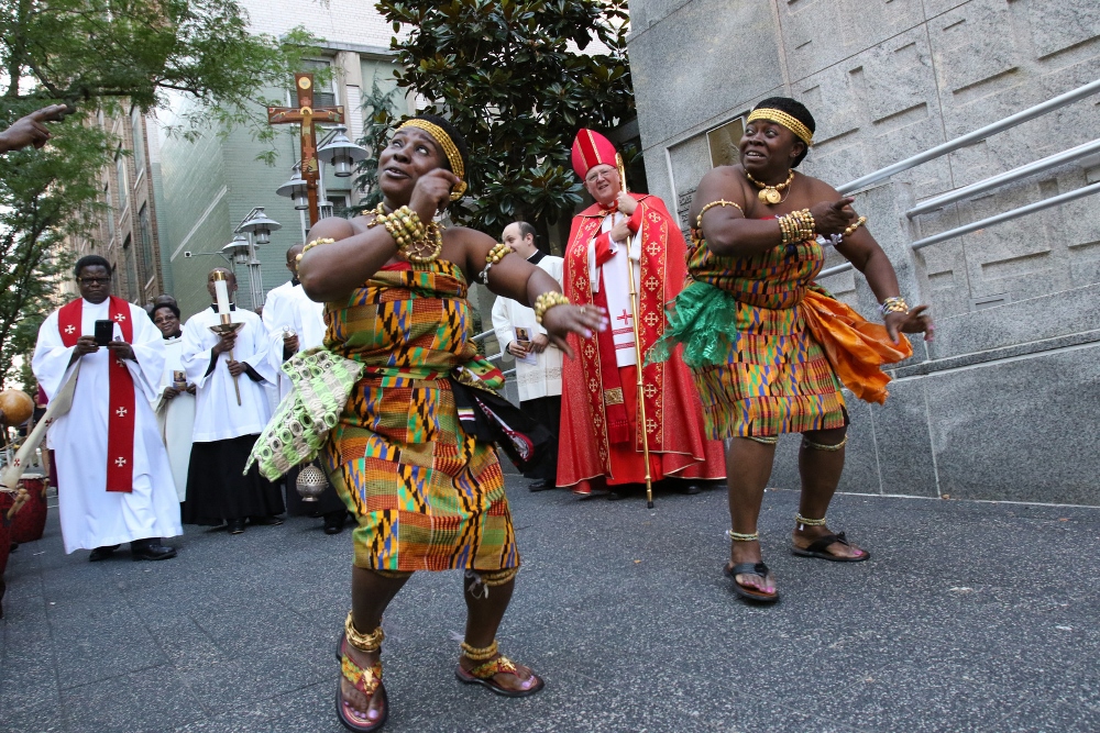 Joyce Serwaa, left, and Gloria Nyame perform a traditional Ghanian dance prior to a special evening prayer service at Holy Family Church in New York City June 29. The liturgy, organized by the Archdiocese of New York's Office of Black Ministry, was celebrated to draw attention to the ongoing persecution and killing of Christians in Africa. (CNS photo / Gregory A. Shemitz)