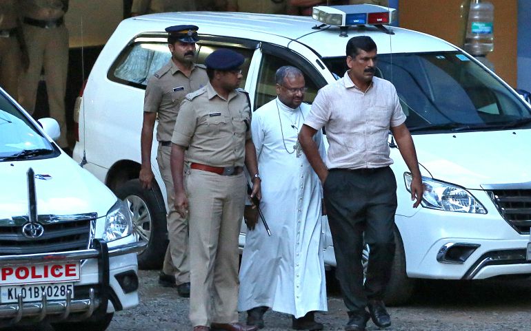 Bishop Franco Mulakkal of Jalandhar, India, is led away for questioning by police Sept. 19 on the outskirts of Cochin. (CNS/Reuters/Sivaram V)