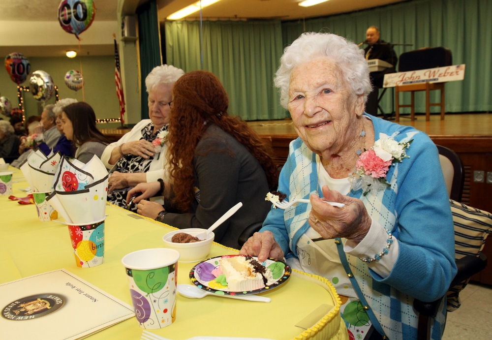 Honoree Mary McQuade, who turned 100 Jan. 3, eats cake during a birthday party for centenarians Jan. 20 at the Little Sisters of the Poor's Queen of Peace Residence. (CNS photo/Gregory A. Shemitz)