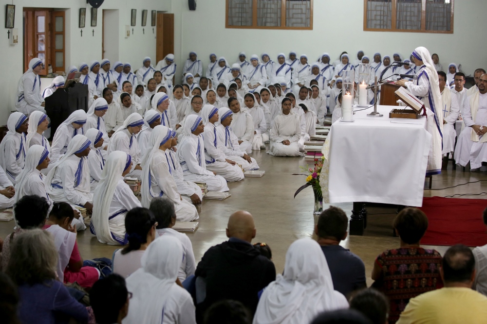Members of the Missionaries of Charity pray Aug. 26 near the tomb of Blessed Teresa of Kolkata, India, in celebration of her birthday. Mother Teresa, founder of the Missionaries of Charity, will be canonized at the Vatican Sept. 4. (CNS photo / Piyal Adhikary, EPA)