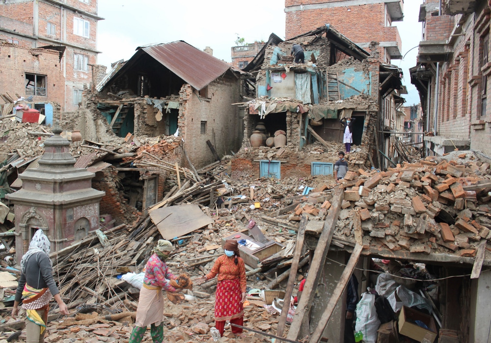 Earthquake survivors of Harsiddhi village on the outskirts of Kathmandu, Nepal, retrieve belongings from their destroyed homes April 29, five days after a major earthquake struck the region. (CNS photo / Anto Akkara)