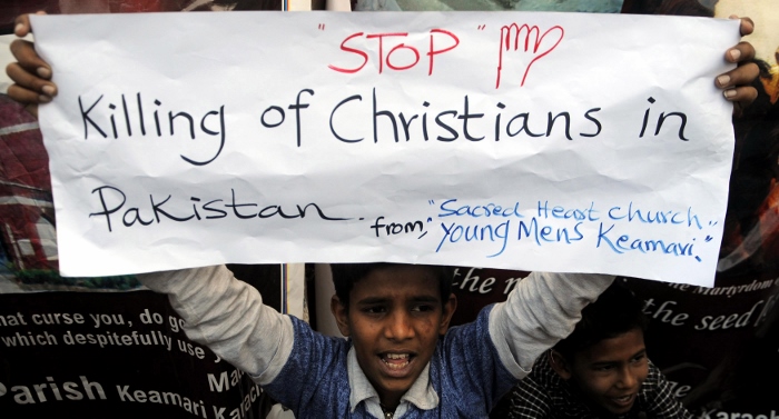 A Pakistani Christian boy holds a banner during a late March protest in Karachi after attacks on churches in Lahore. The U.S. State Department's annual report on the status of religious freedom around the world was released in Washington Oct. 14. (CNS photo/Shahzaib Akber, EPA)