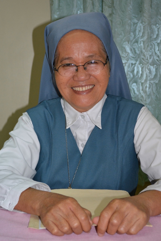 Sr. Porferia Ocariza, a member of the Daughters of St. Paul, poses for a photo Feb. 19 in Pasay City, Philippines. Sister Ocariza helped lead the rosary during the People Power uprising in the Philippines 30 years ago to oust dictator Ferdinand Marcos. (CNS photo / Simone Orendain)