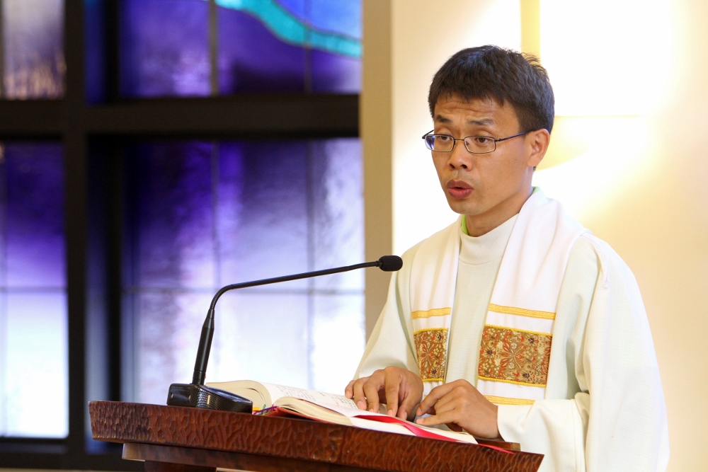 Fr. Joseph Su Xin of the Diocese of Baoding, China, proclaims the Gospel during Mass at the Cenacle Retreat Center in Ronkonkoma, N.Y., Aug. 20. Su, a participant in Maryknoll's Chinese Seminary Teachers and Formators Project, is pursuing a master's degree in spiritual direction at Fordham University in New York. (CNS photo/Gregory A. Shemitz)