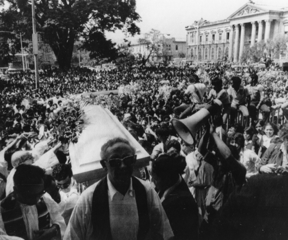 Thousands gather outside the Metropolitan Cathedral in San Salvador March 30, 1980, as the casket of slain Archbishop Oscar Romero is carried inside for a funeral Mass. (Scan of CNS file photo)