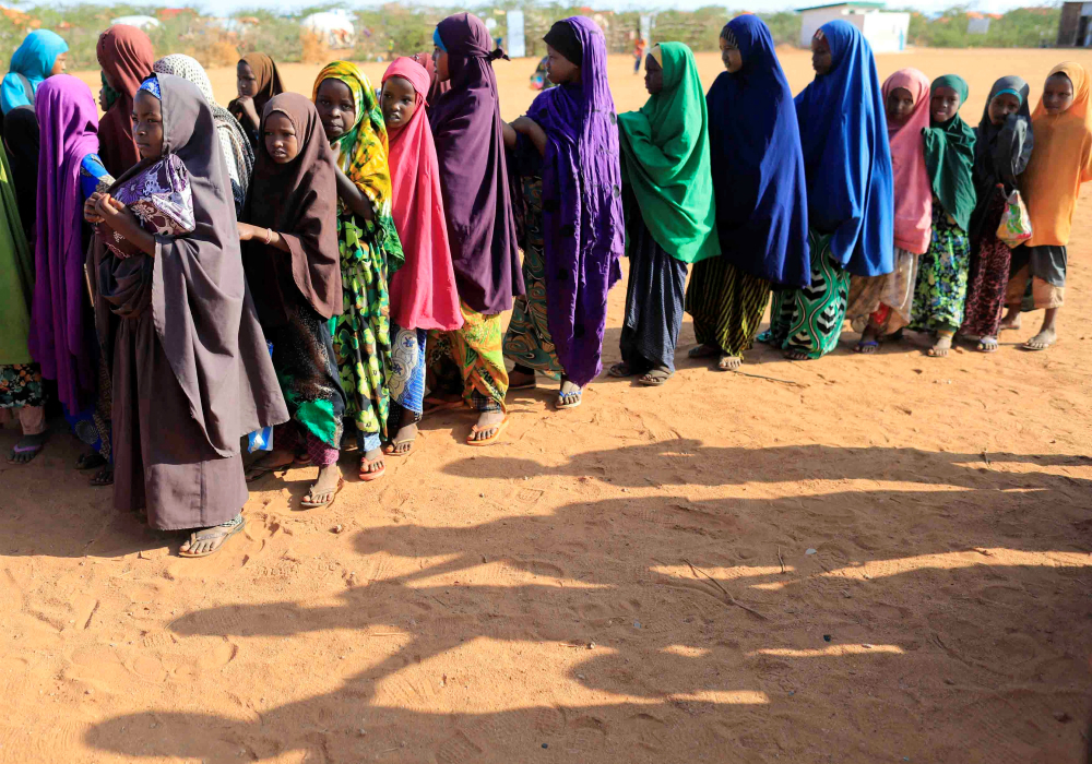 A group of internally displaced Somali girls wait in line before attending school April 4 at a camp in Dollow, Somalia. (CNS photo/Zohra Bensemra, Reuters)