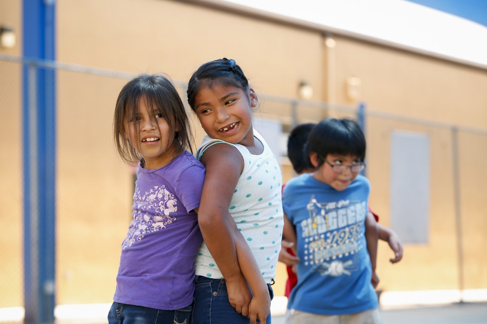 Aubrey Rivera and Leila Molina pair up for an exercise during PE class. The work of the Franciscan Sisters of Christian Charity there has attracted high-profile benef actors such as baseball legend Joe Garagiola. (CNS photo / Nancy Wiechec)