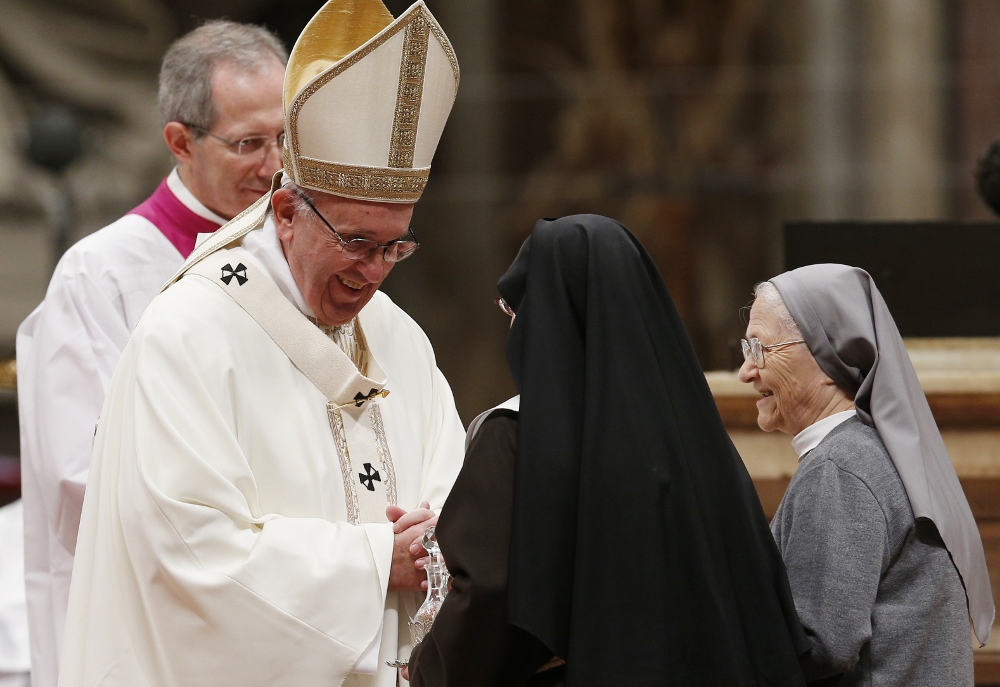 Pope Francis accepts offertory gifts from nuns as he celebrates a Mass with religious in St. Peter's Basilica at the Vatican Feb. 2. The Mass concluded the Year of Consecrated Life. (CNS photo / Paul Haring)