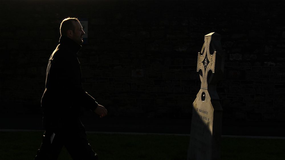 A man walks past a memorial to those who worked in the Magdalene laundries, at Glasnevin Cemetery in Dublin Feb. 6, 2013. (CNS / Reuters / Cathal McNaughton)