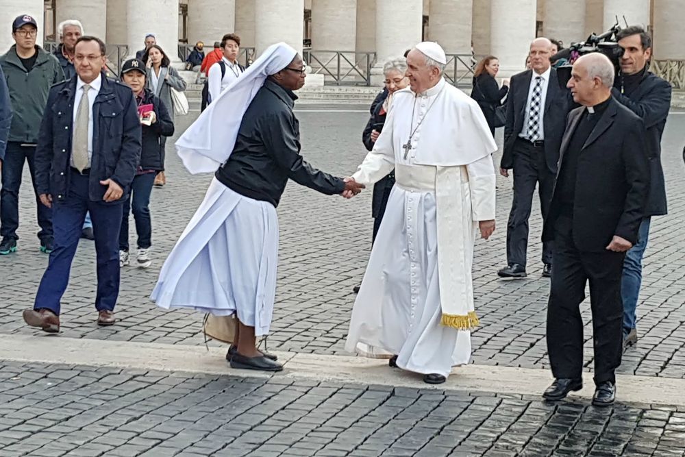 Pope Francis greets a woman religious in St. Peter's Square at the Vatican Nov. 16, 2018. (CNS / Junno Arocho Esteves)