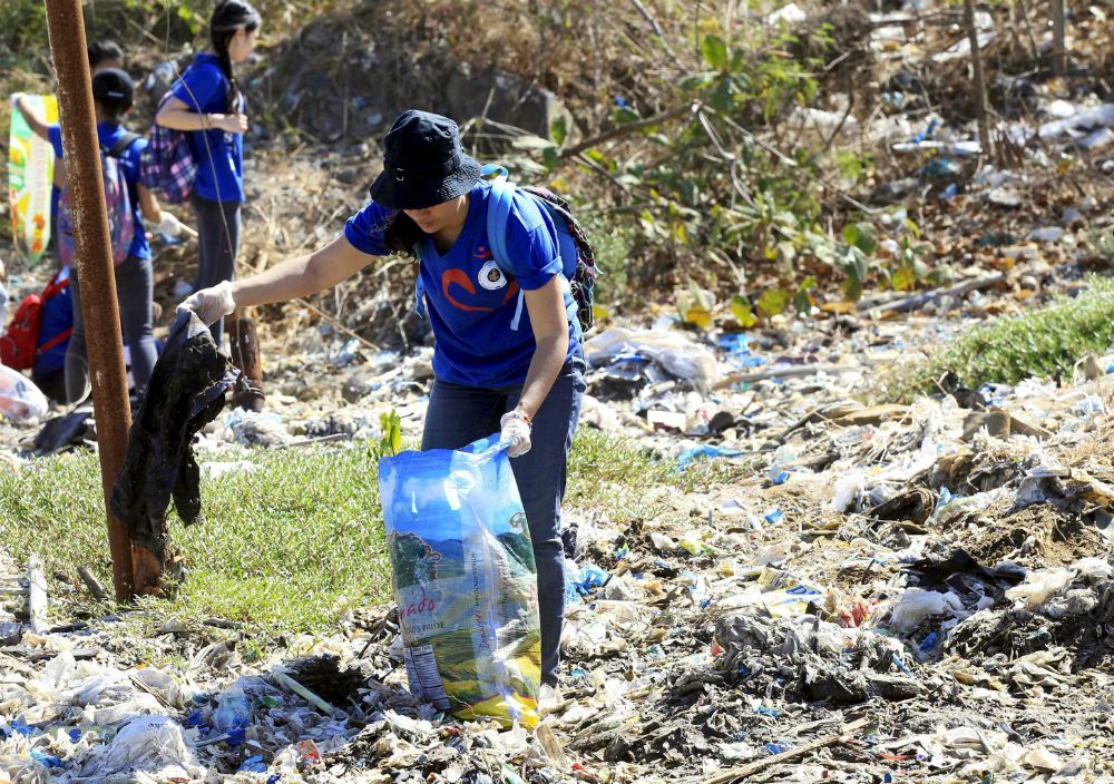 A volunteer picks up trash at Freedom Island, a marshland considered to be a sanctuary for birds, fish and mangroves in a coastal area of Las Pinas City, near Manila, Philippines, April 2015. (CNS/Reuters/Romeo Ranoco)