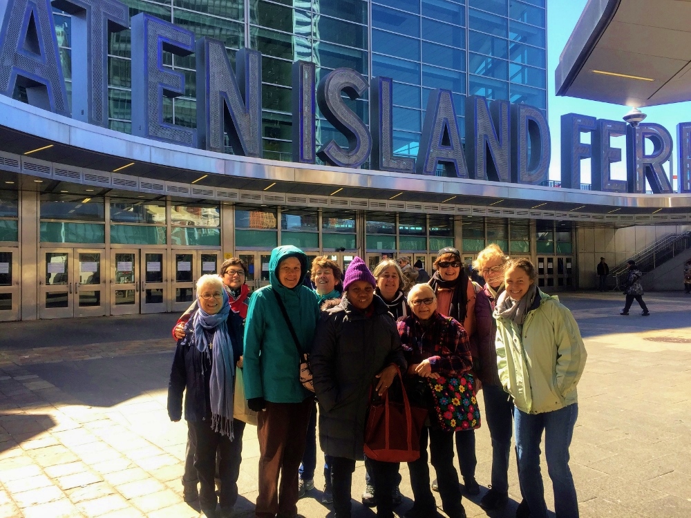 The group the Dominican Leadership Conference hosted for the Commission on the Status of Women poses at the Staten Island Ferry dock in New York City. The group rode the ferry as a tourist activity during their two-week visit to the U.N. (Viviana Garcia-Blanco)