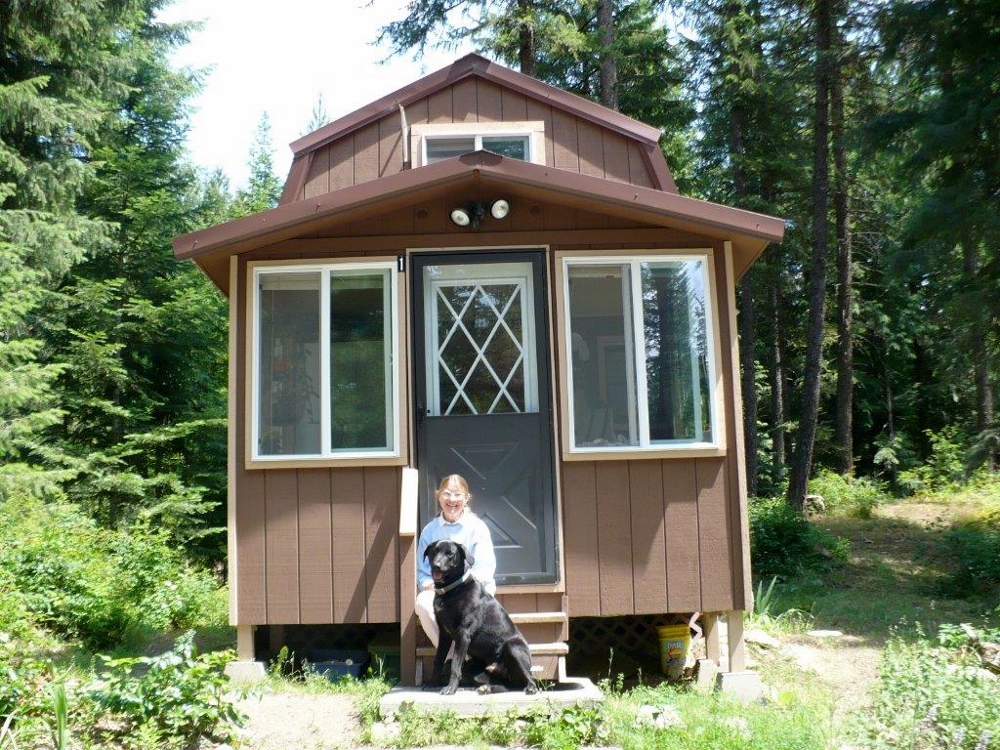Sr. Nancy Casale sits on the steps of one of the five hermitage houses at the Carmel compound. (Provided photo)