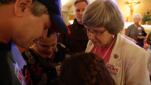 Sr. Simone Campbell listening to a Cuban family who traveled 18 hours to one of the Nuns on the Bus 2013 stops so they could talk to her and the crowd about their personal immigration plight. (Melissa Regan)