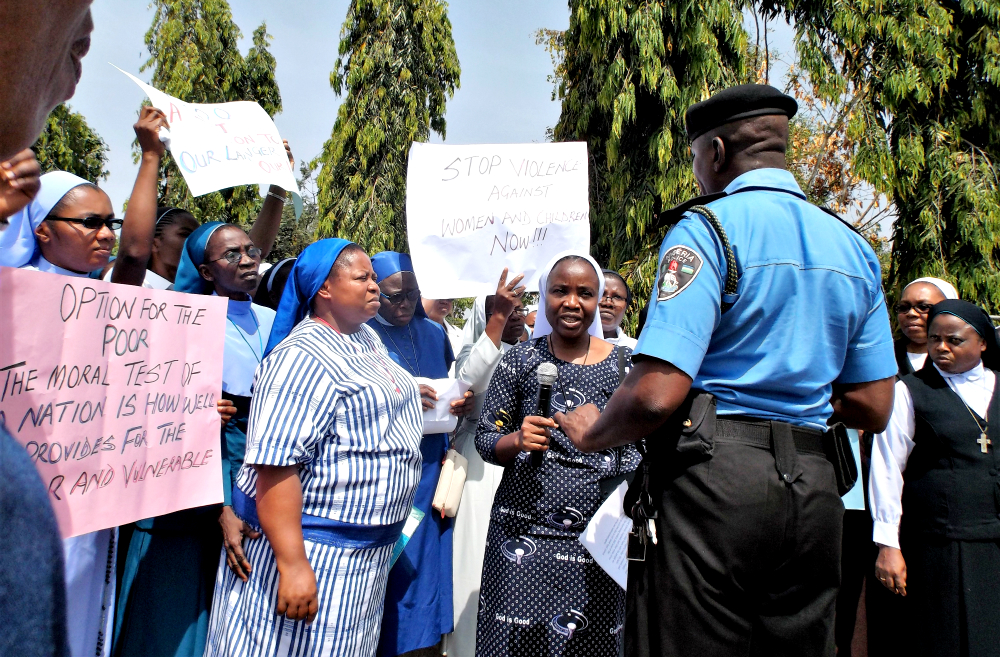 The sisters talk with police at the entrance to the National Assembly in Abuja, Nigeria, Nov. 24. (Provided photo)