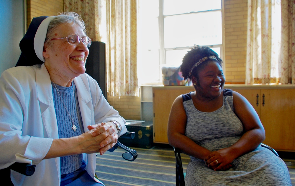 St. Casimir Sr. Margaret Zalot laughs with volunteer Diana Lockett at the Maria Kaupas Center, which provides afterschool programs in a Chicago neighborhood that has struggled with poverty, justice and sometimes violence. (GSR photo / Dan Stockman)