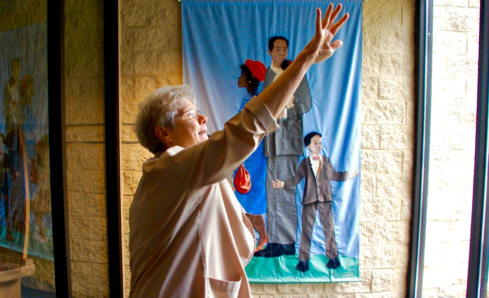Springfield Dominican Sr. Joanne Delehanty explains the features of the entrance to St. Benedict the African Catholic Church in Chicago's Englewood neighborhood. (GSR photo / Dan Stockman)