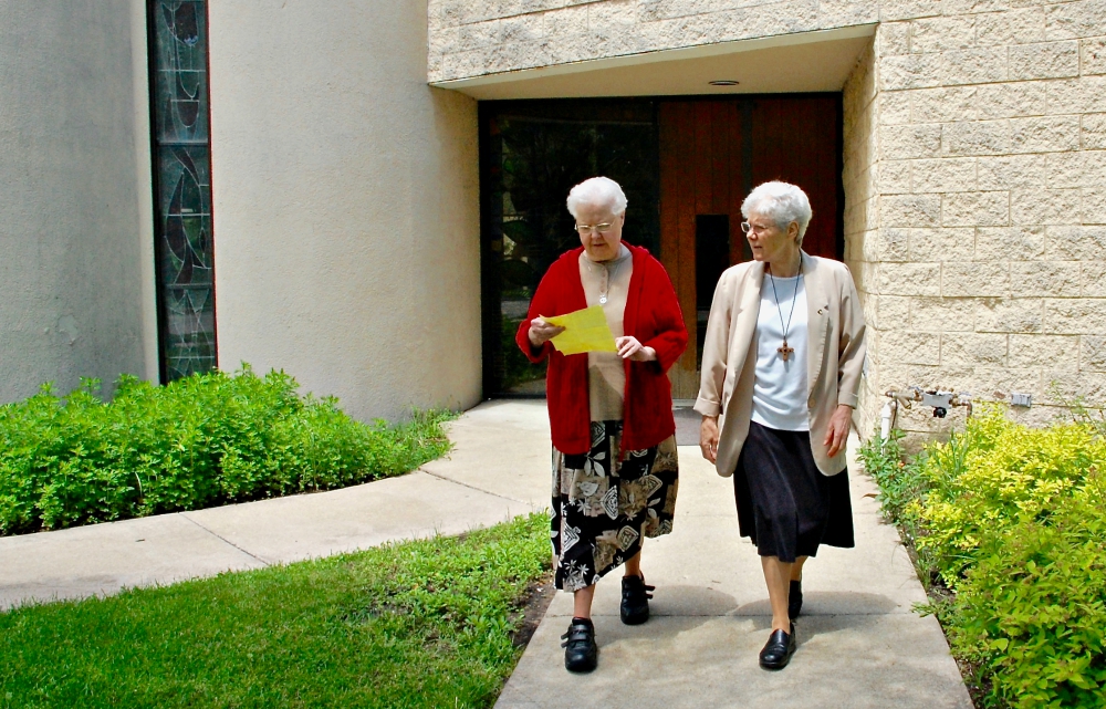 Springfield Dominican Srs. Mary Pokorny, left, and Joanne Delehanty outside St. Benedict the African Catholic Church in Chicago's Englewood neighborhood (GSR photo / Dan Stockman)