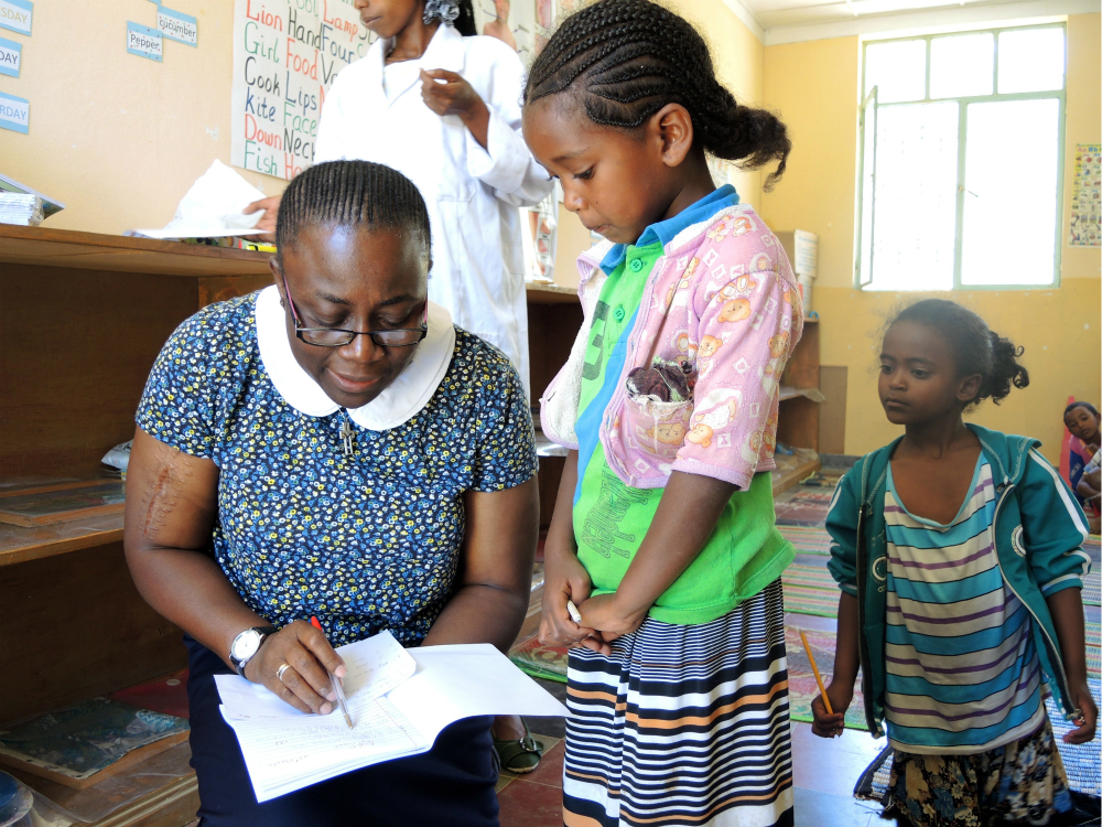 St. Louis Sister Sr. Justina Ihechere reviews a student's English work at the preschool that is part of the sisters' mission in Dawhan, Ethiopia. (GSR photo / Melanie Lidman)