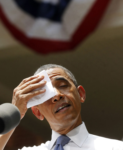 U.S. President Barack Obama pauses and wipes his forehead as he talks about his vision to reduce carbon pollution June 25 during a speech at Georgetown University in Washington. (CNS/Reuters/Larry Downing)
