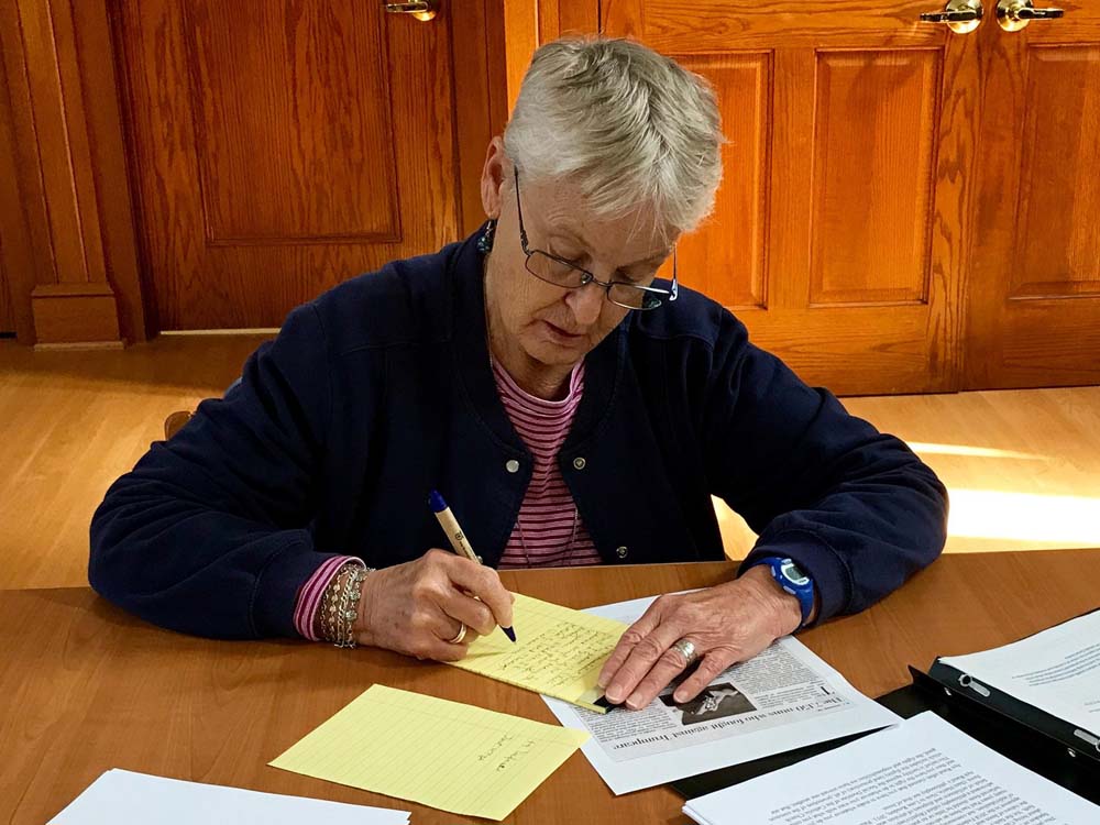 Sr. Edith Hart of the Religious of the Sacred Heart of Mary writes her letter to House Speaker Paul Ryan (Photo courtesy of the A Fair and Moral Budget: Nuns Write Letters to Paul Ryan Facebook page)