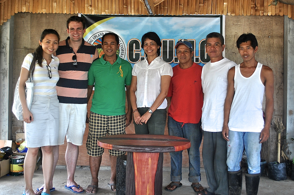 Fair Trade practitioner Vie Reyes, Treasurer of Bote Central Inc. (center in white shirt) brought London-based coffee roaster representatives Jena and Julian Krause (left) to meet coffee farmer leaders in Cabuyao, Laguna on May 7. (N.J. Viehland)