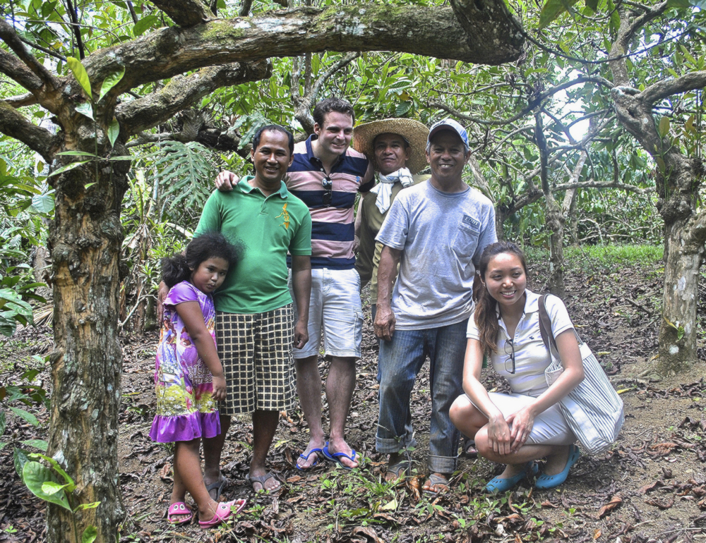 Jojo Andal (in green), president of a farmers' marketing cooperative with members show London-based coffee roasters Jena and Julian Krause part of their 25-hectare farm in Laguna, Philippines, which is planted with three varieties of coffee. (N.J. Viehland)