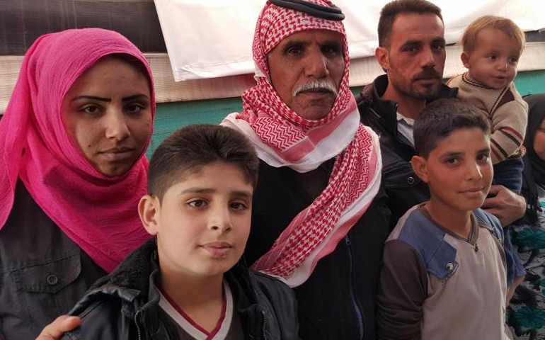 The family of Abdel Karim, third from left, who fled the city of Aleppo, Syria, in 2012 and are living, as many Syrian refugees do, in tents. In their case, they are staying not far from the city of Zahle, Lebanon. (GSR photo / Chris Herlinger)