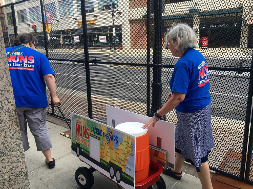 Sr. Susan Rose Francois, left, and Sr. Simone Campbell pull their lemonade wagon down the street Monday in Cleveland. (Ashley Wilson / Courtesy of NETWORK)