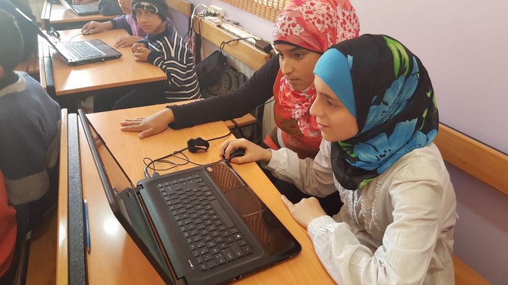 Syrian refugee children learn computer skills at a community center of the Good Shepherd Sisters in Deir al-Ahmar in Lebanon's Beqaa Valley. (GSR photo / Chris Herlinger)