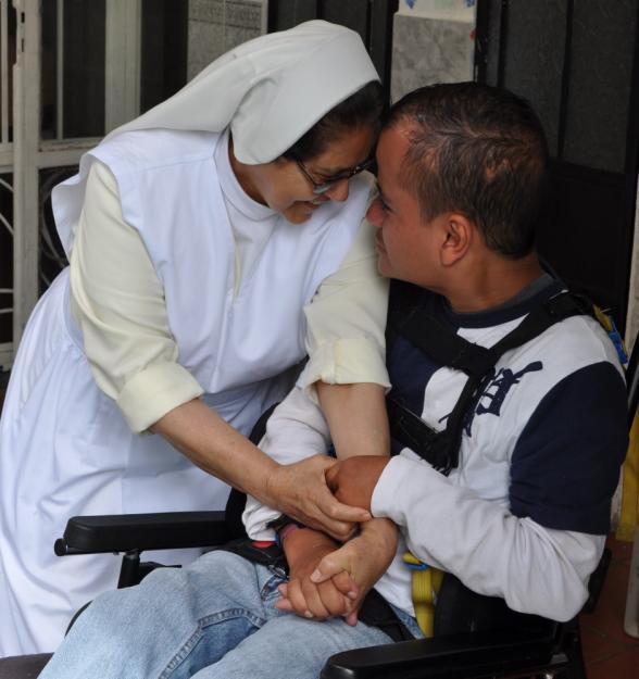 Sr. Dolores Ochoa hugs a developmentally disabled 28-year-old at the Home of Marina Leal Guirola a, an orphanage run by Somoscan Missionary Sisters. Many of children are abandoned at birth and it is left to the church to provide for their care. (GSR photo / J. Malcolm Garcia)